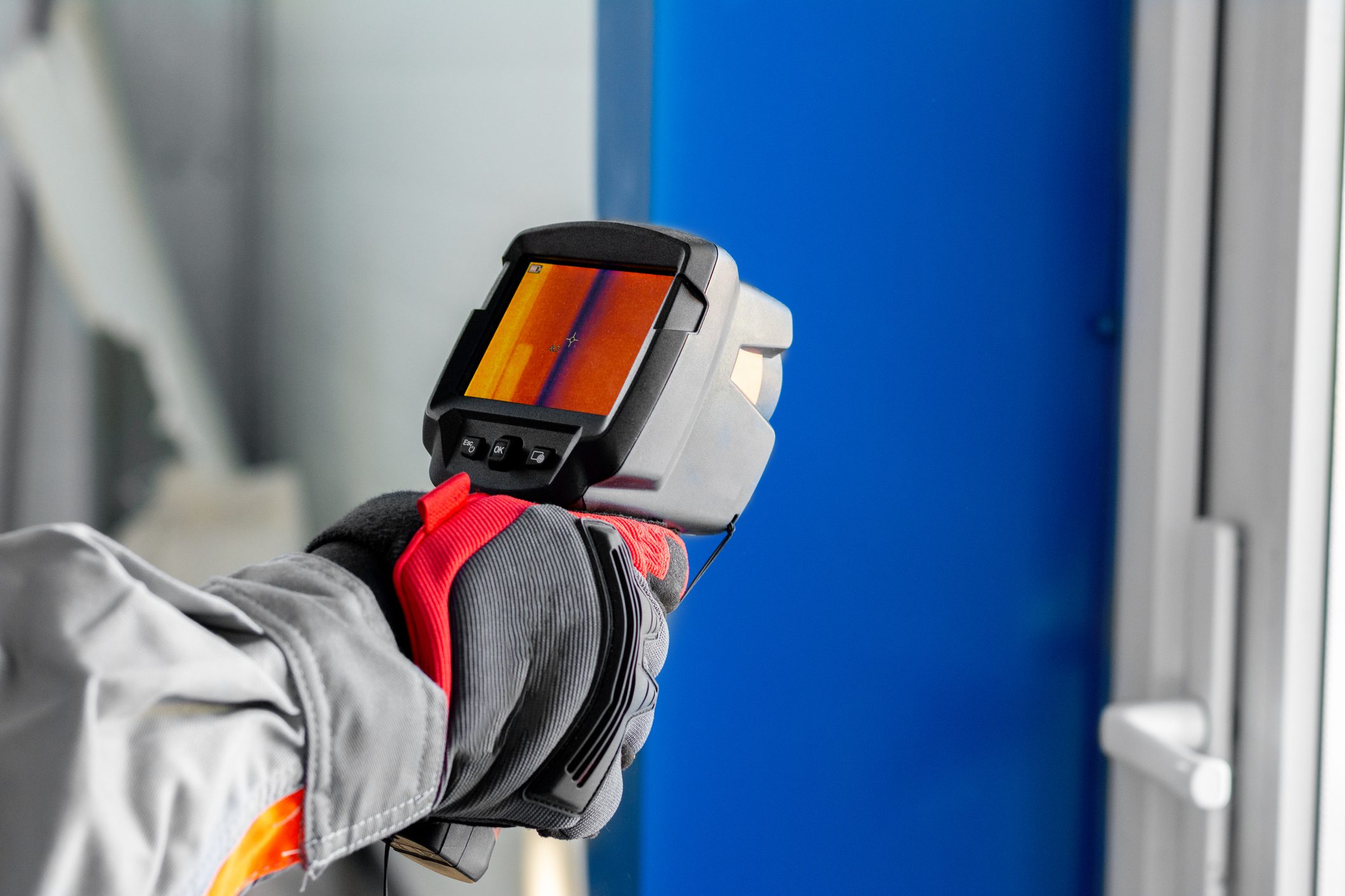 Thermal camera inspecting door for heat loss.